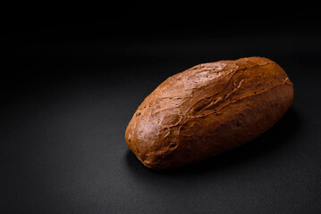Delicious fresh crispy loaf of white bread with grains and seeds