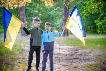 flags of Ukraine in hands of two boys. Children hold Ukrainian f