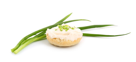 Tasty crouton with cream cheese and green onion on white background