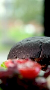 black bread bun with cuttlefish ink sandwich cheeseburger hamburger restaurant serving with salad on black plate near window delicious appetizing bulgogi, spicy bulgogi, house-made, squid inc bread