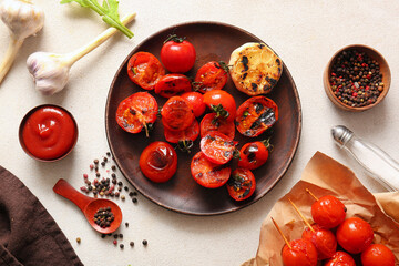 Baking paper and plate of skewers with tasty grilled tomatoes on white background