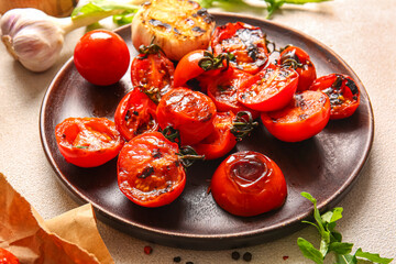 Plate with tasty grilled tomatoes and garlic on white background
