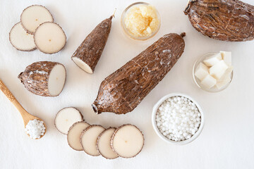Cassava root on white background with tapioca pearls
