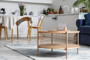 Wooden coffee table in interior of open plan kitchen