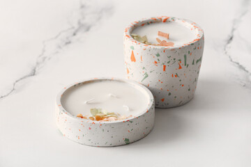 Holders with candles on white background