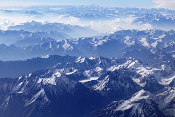 Breathtaking aerial view of the Indian and Nepalese Himalayas, featuring snow-covered Mt. Everest and other majestic peaks. A mesmerizing snapshot captured during a scenic flight from Delhi to Leh.