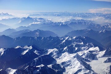 Captivating aerial perspective showcasing the majestic beauty of the Indian and Nepalese Himalayas. This enchanting snapshot was seized amidst a picturesque journey from Delhi to Leh, leaving viewers 