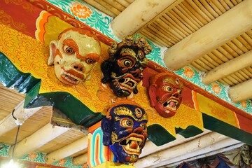 Colorful Tibetan Dancing Masks hang gracefully from a monastery column in Likir Monastery, Ladakh,...
