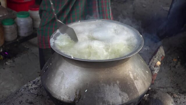 Rice boiling in hot water. View of rice boiling in aluminum pot. Close-up view of steaming boiling hot water.