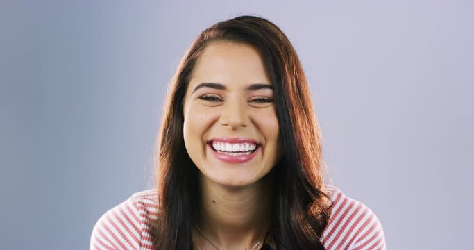 Face, smile and funny with a woman laughing in studio against a purple background for humor or comedy. Portrait, comic or joking and a happy young female person looking silly or goofy with laughter