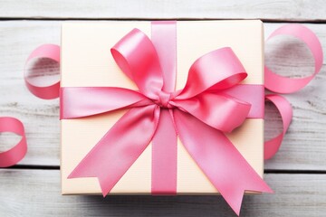 gift box with a pink ribbon on a wooden surface