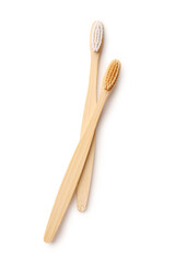 Different bamboo toothbrushes on white background