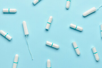 Menstrual tampons on blue background - obrazy, fototapety, plakaty