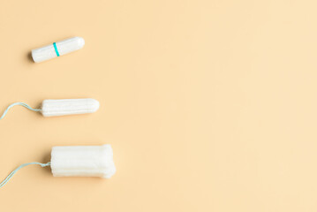 Different menstrual tampons on beige background