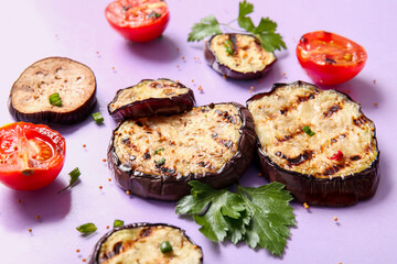 Delicious grilled eggplants, tomatoes, parsley and spices on lilac background