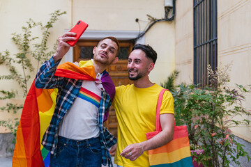 Joyful Gay Friends Celebrating Pride, Capturing Selfie at Home with Vibrant LGBT Accessories