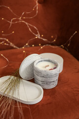 Holder with candle on fabric background, closeup