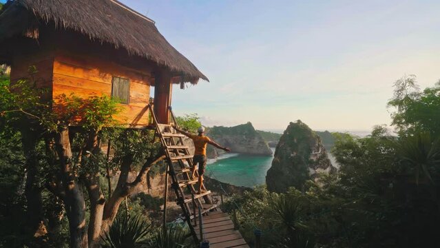 Active lifestyle travel people standing at wooden hut and enjoy beautiful view tropical beach 4K
