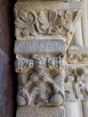 Romanesque capital of lions eating a man in the church of Santa Maria of Baldos, Montanana, Huesca, Spain.