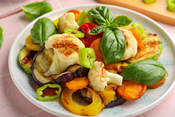 Plate with grilled vegetables and basil, closeup