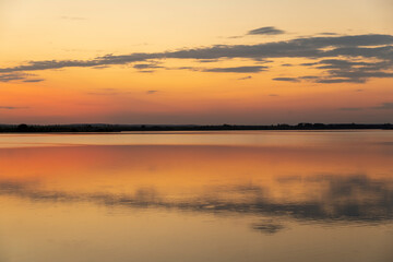 Fototapeta na wymiar multicolored sky during sunset on the lake