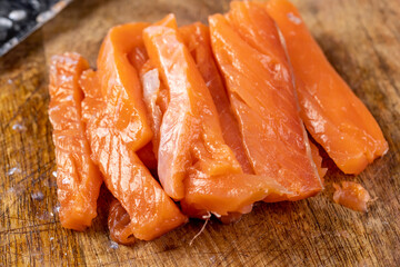 Sliced red trout meat with sea salt