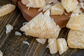 Freshly peeled pink pomelo on the table