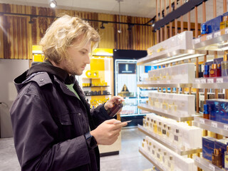 buying make up at cosmetics section in store. choosing cosmetics, perfumes, creams and shampoos, Using tester.