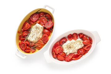 Baking dishes of tasty tomatoes with feta cheese on white background