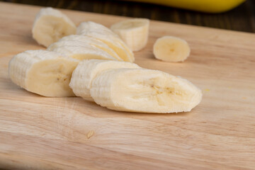 Fototapeta na wymiar a ripe sweet banana cut into pieces lies on the table