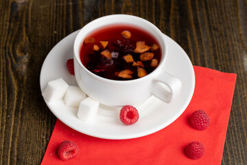 Red raspberry tea with pieces of fruit and berries
