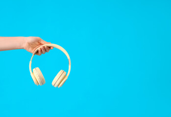 Woman with headphones on blue background