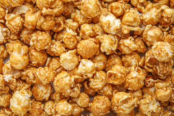 Tasty caramel popcorn as background