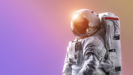 Astronaut isolated on neon gradient background.  Spaceman alone. Sci-fi space wallpaper with bright light and man in spacesuit. Elements of this image furnished by NASA