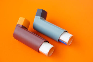 Asthma inhalers on orange background. Concept, Pharmaceutical products for treatment symptoms of...