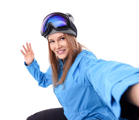 Beautiful woman in ski goggles taking selfie on white background