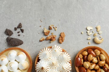 Many different tartlets on grey table, flat lay with space for text. Delicious dessert