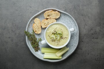 Delicious celery soup on gray table, top view