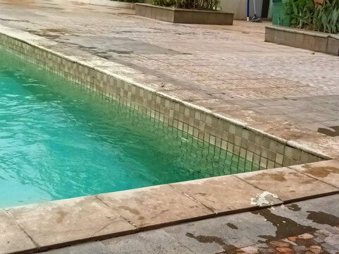 Corner swimming pool details. Natural stone pool edge. The edge of the swimming pool boundary. Swimming pool boundary wall cover.