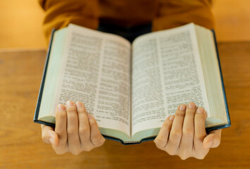 Topview of Asian Young woman reading a holy book or a book enjoys of rest.