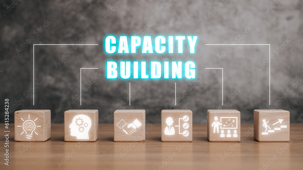 Poster capacity building concept, wooden block on desk with capacity building icon on virtual screen.