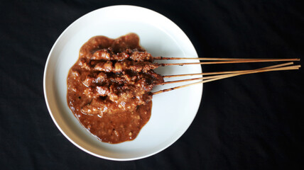 peanut sauce chicken satay on a plate