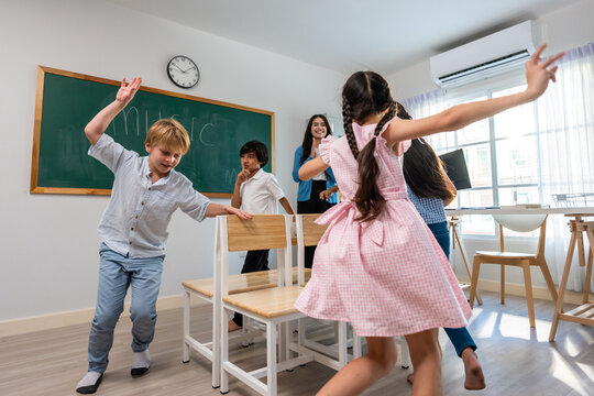 Group of student learn with teacher in classroom at elementary school. 