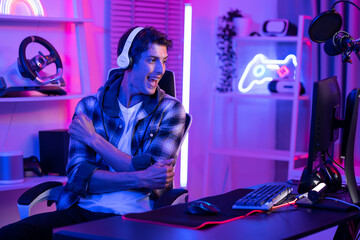Caucasian young Esport male gamer play online video game on computer. 