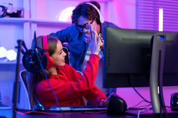 Caucasian team of e-sport gamer playing online video game on computer.  © Kawee