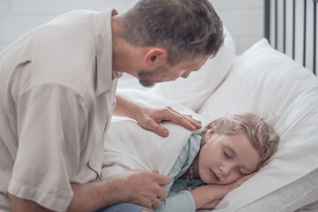Fototapeta premium Father singing his daughter to sleep, providing comfort, support, and security. Focusing on fulfilling both physical and emotional needs. Kids sometimes act happy while pretending to fall asleep.