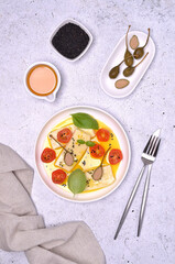 Soft cheese slices with tomatoes