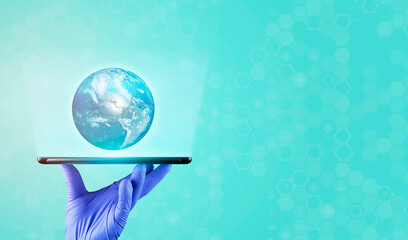 world health day concept. The doctor's hand holds a tablet. a hologram of the isolated globe is...