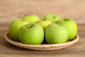 Green apple fruit in basket on wooden background, Healthy fruit