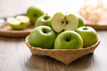 Green apple fruit in basket on wooden background, Healthy fruit